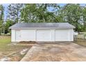 White detached garage with two doors and a concrete driveway at 119 Silver King Ave, Cross, SC 29436