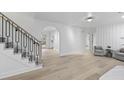 Bright living room boasts hardwood floors, modern staircase, and elegant archway at 1228 Penny Cir, Mount Pleasant, SC 29464