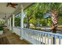 View from a covered porch featuring white columns, wood floors, and a ceiling fan at 1483 Harborsun Dr, Charleston, SC 29412