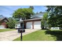 Lovely home with a two-car garage, inviting front porch, and neatly maintained lawn and landscaping at 15 Muirfield Village Ct, Summerville, SC 29483