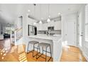 Bright kitchen features stainless appliances, white cabinets, marble countertops and hardwood floors at 1624 Prince Edward St, Mount Pleasant, SC 29466