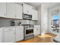 Well-equipped kitchen with stainless steel appliances, white cabinets, and light countertops at 1624 Prince Edward St, Mount Pleasant, SC 29466