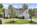 Inviting single-story home featuring a lush front yard and attached two car garage at 1634 Pin Oak Cut, Mount Pleasant, SC 29466