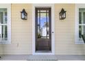 Elegant front door framed by stylish lanterns, creating a warm and welcoming entrance at 1658 Pierce St, Charleston, SC 29492