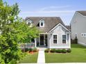 Lovely home featuring a well-maintained lawn, covered porch, and gray siding at 1722 Winfield Way, Charleston, SC 29414