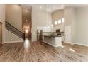 Spacious living room and kitchen area with hardwood floors, white cabinets, and modern appliances at 1730 Refuge Dr, Ladson, SC 29456