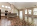 Open-concept living space with wood floors, bright windows, and a gourmet kitchen at 1730 Refuge Dr, Ladson, SC 29456