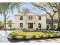 Beautiful two-story white brick home featuring a second-story balcony and landscaped front yard at 19 Ponce De Leon Ave, Charleston, SC 29407