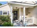 Inviting front porch with decorative accents, plants, and a charming welcome area at 203 Eagle Ridge Rd, Summerville, SC 29485