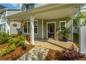 Inviting front porch with decorative plants, seating, and charming details, offering a warm welcome at 203 O'Malley Dr, Summerville, SC 29483