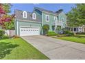 Two-story home with an attached garage and long driveway, showcasing curb appeal at 219 Silverwood Ln, Summerville, SC 29485