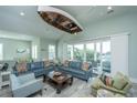 Bright living room featuring two sofas, and sliding glass doors to the outdoor deck at 2501 Myrtle St, Edisto Beach, SC 29438
