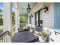 Cozy front porch features a hanging swing and stylish decor, offering a welcoming entryway to the home at 2522 Daniel Island Dr, Daniel Island, SC 29492