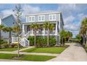 Two-story house with a metal roof, landscaped yard, and a charming porch on the main level at 2522 Waverly St, Charleston, SC 29492