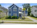 This two-story home features a blue exterior, well-kept landscaping, and a cozy front porch at 2557 Hatch Dr, Johns Island, SC 29455