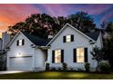 Charming two-story home with inviting curb appeal, featuring manicured landscaping during a colorful sunset at 2560 Palmetto Hall Blvd, Mount Pleasant, SC 29466