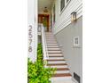 Inviting front porch with beautiful wooden door, staircase and stylish lighting fixture at 2578 Helmsman Rd, Johns Island, SC 29455