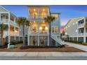 Charming two-story beach house with stairs leading to the porch and second-story deck at 2924 Tranquility Rd, Mount Pleasant, SC 29466