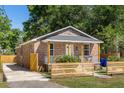 Lovely brick house with a fenced front yard and an inviting porch, showcasing great curb appeal at 2957 Alabama Dr, North Charleston, SC 29405
