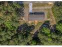 Overhead view of single-story home nestled in a vibrant green forest, showing the roof and surrounding landscape at 314 Hickory Nut Way, Cross, SC 29436