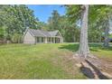 Cozy home surrounded by lush greenery and mature trees, has a well-maintained lawn and fenced side yard at 333 Price St, Goose Creek, SC 29445