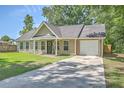 Inviting home features a well-kept lawn, driveway, attached garage, and a lovely front entrance with a decorative wreath at 333 Price St, Goose Creek, SC 29445