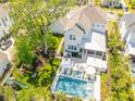 Aerial view showcasing a backyard oasis with a pool, lounge chairs, and playful swing set at 3688 Goodwater St, Mount Pleasant, SC 29466