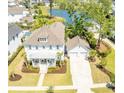 Stunning aerial view of a bright white home with a detached garage and backyard pond at 3688 Goodwater St, Mount Pleasant, SC 29466