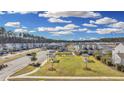 Beautiful aerial view of community park, homes, and landscaping with pond at 404 Snowy Plover Ln, Summerville, SC 29486