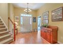 Bright foyer with hardwood floors, staircase, chandelier, and elegant decor at 405 Decatur Dr, Summerville, SC 29486