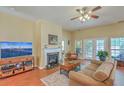 Cozy living room with a fireplace, ceiling fan, and ample natural light at 405 Decatur Dr, Summerville, SC 29486