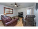 Comfortable living room with hardwood floors, ceiling fan, and plush leather seating at 4515 Holmes Ave, North Charleston, SC 29405