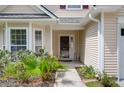 A close-up of a charming front door and the meticulously manicured yard at 4856 Carnoustie Ct, Summerville, SC 29485