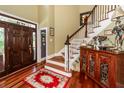 Inviting foyer with hardwood floors, staircase, dark wood door, and decorative accents at 4991 Sound View Dr, Mount Pleasant, SC 29466
