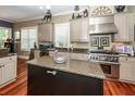 Bright kitchen featuring granite countertops, stainless steel appliances, and a large island for food preparation at 4991 Sound View Dr, Mount Pleasant, SC 29466