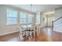 Open concept dining room with hardwood floors and natural lighting leading into the foyer and kitchen at 508 Alderly Dr, Moncks Corner, SC 29461