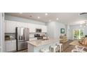 Bright, open-concept kitchen with stainless steel appliances, granite counters, and a breakfast bar at 511 Kitsap Ct, Summerville, SC 29486