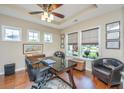 Well-lit home office with hardwood floors, stylish furniture, and large windows offering a pleasant view at 511 Nandina Dr, Goose Creek, SC 29445