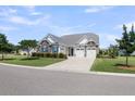 Attractive single-Gathering home showcasing a manicured lawn and three-car garage at 522 Tidewater Chase Ln, Summerville, SC 29486