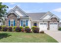Charming single-story home with lush landscaping and blue shutters at 522 Tidewater Chase Ln, Summerville, SC 29486