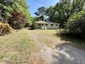 Charming home situated on a spacious lot with mature trees lining the driveway at 6086 Chisolm Rd, Johns Island, SC 29455