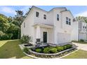 Inviting two-story home featuring manicured landscaping, a welcoming entrance, and a two-car garage at 707 Jancus St, Charleston, SC 29414