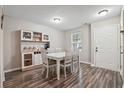 Inviting dining area with wood floors, white table set, and natural light from the window at 7999 Vermont Rd, North Charleston, SC 29418