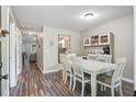Bright dining room with hardwood floors, a large table, and a charming hutch at 7999 Vermont Rd, North Charleston, SC 29418
