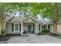 Inviting home exterior with manicured landscaping, a cozy porch, and fresh, neutral paint at 7999 Vermont Rd, North Charleston, SC 29418