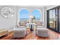 Cozy sitting area with stylish chairs and a tranquil ocean view through arched windows at 9002 Palmetto Dr # 119, Isle of Palms, SC 29451