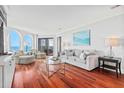 Open living room with ocean views, comfortable seating, and beautiful hardwood floors at 9002 Palmetto Dr # 119, Isle of Palms, SC 29451
