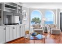 Living room features built-in shelves, comfortable seating, and stunning ocean views at 9002 Palmetto Dr # 119, Isle of Palms, SC 29451
