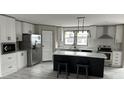 Modern kitchen with white cabinets, stainless steel appliances, and a kitchen island at 945 Tiger Loop, Saint Stephen, SC 29479