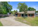 Front exterior view of single-story home with brick facade, green lawn, and long driveway at 9630 Crosscut Dr, Ladson, SC 29456